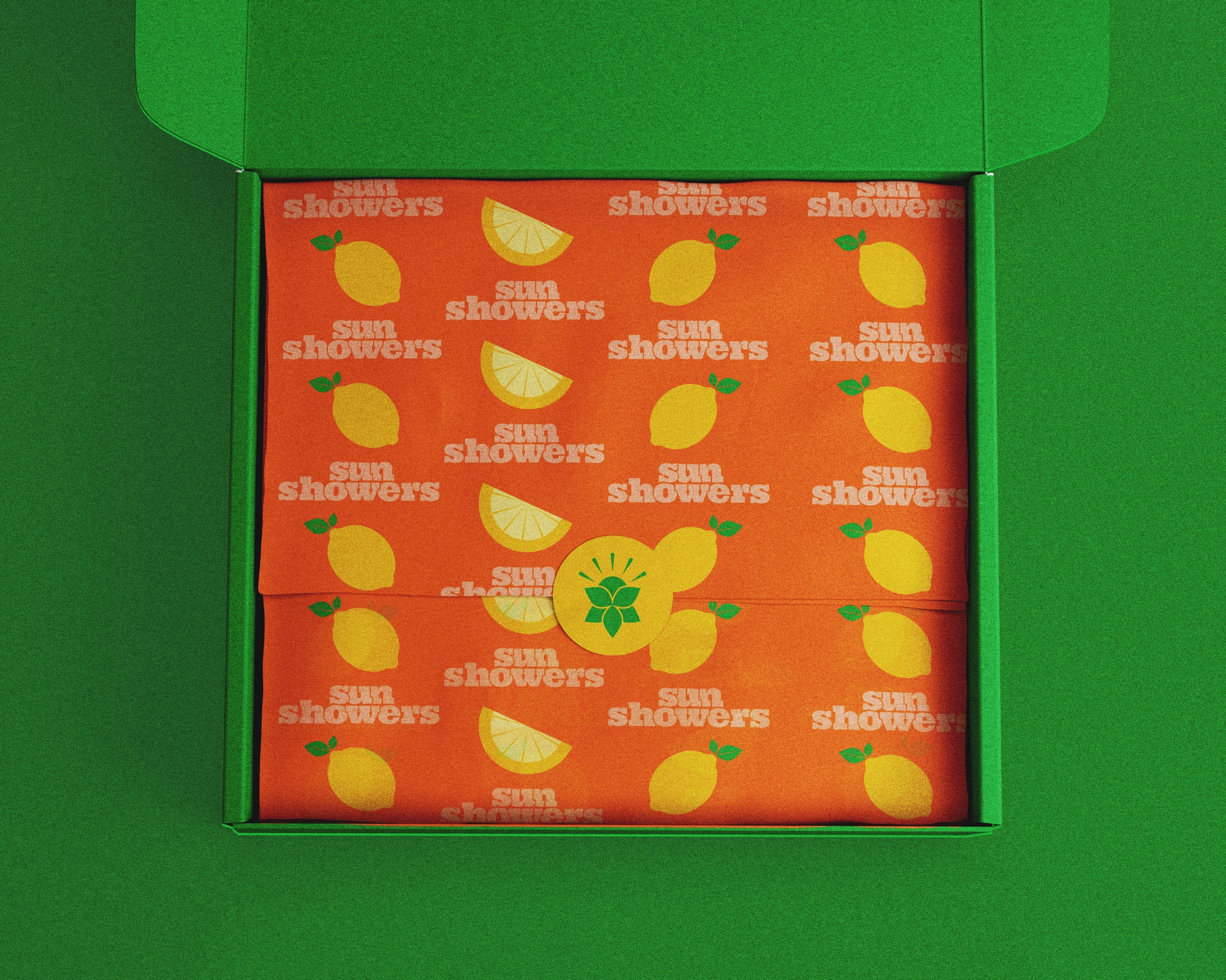 An open box that has packaging paper inside with the lemonade pattern.