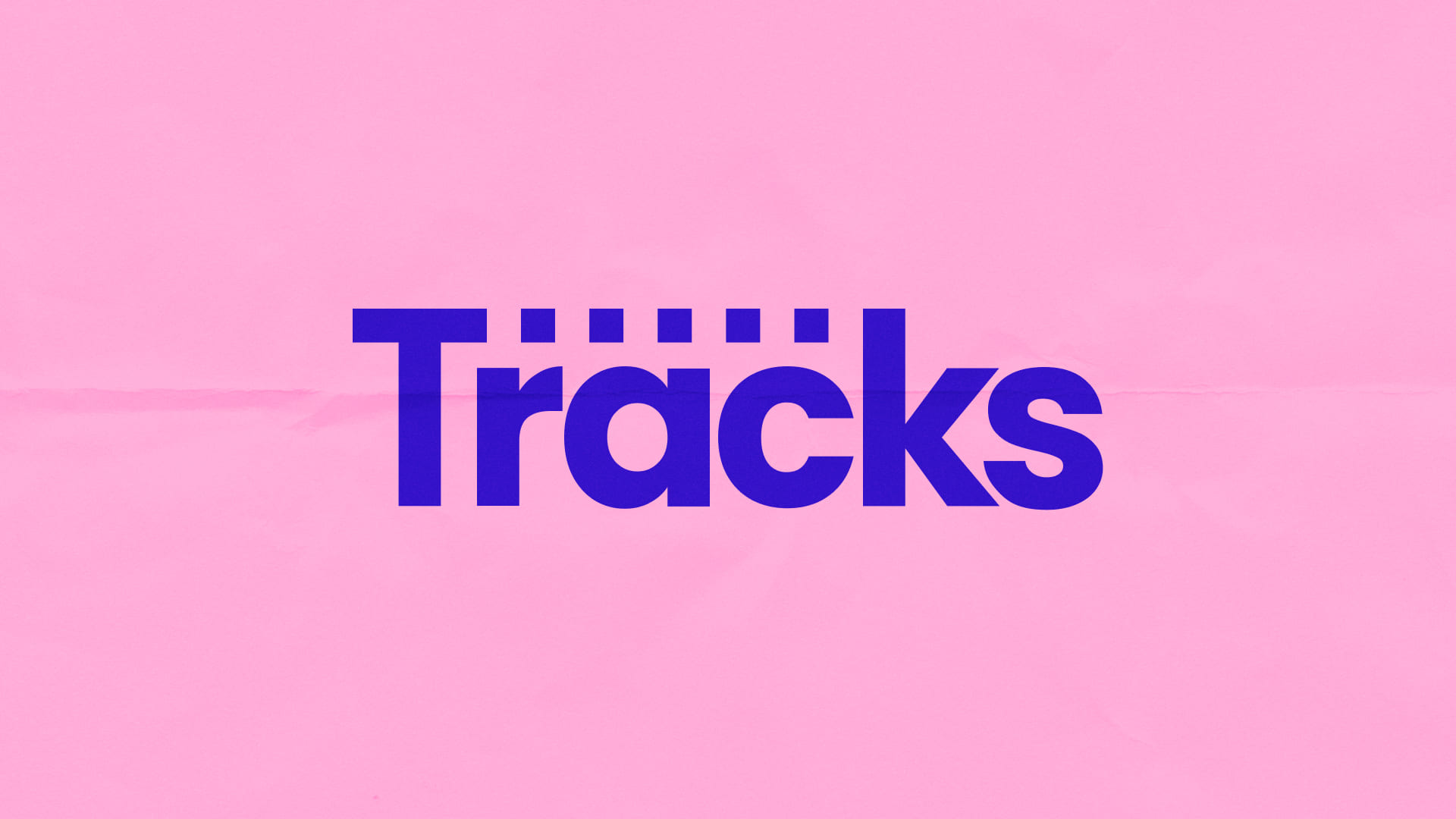 The primary logo for Tracks layed on top of a pale pink background.